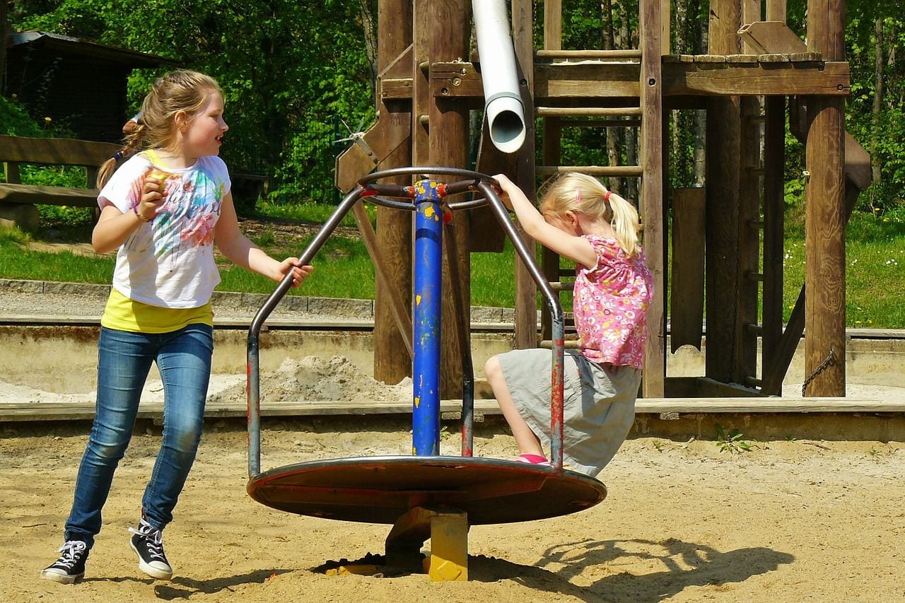 Four children playing in a playground - Stock Image - F033/7416 - Science  Photo Library